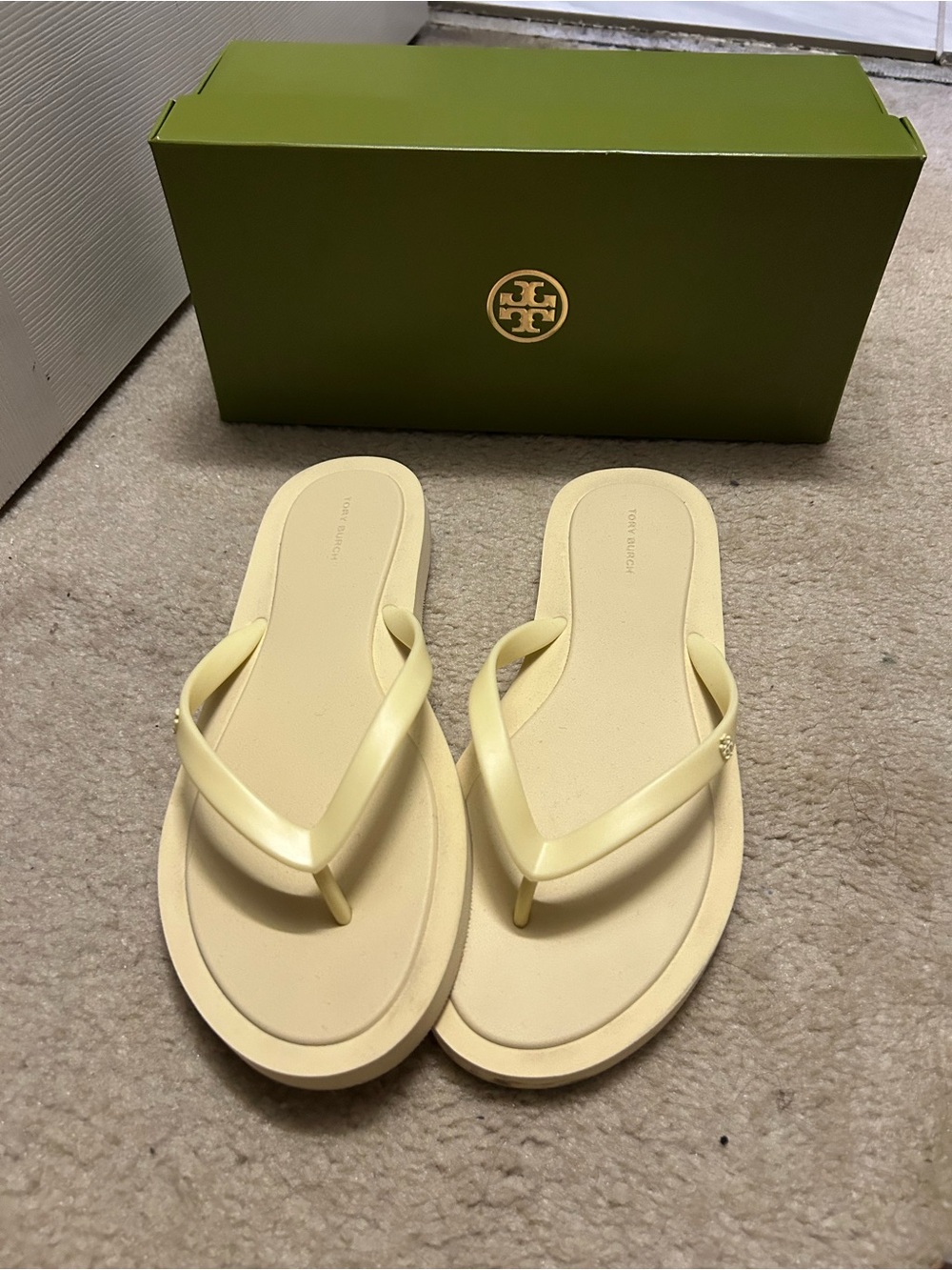 TORY BURCH KIRA padded flip flops in light yellow.